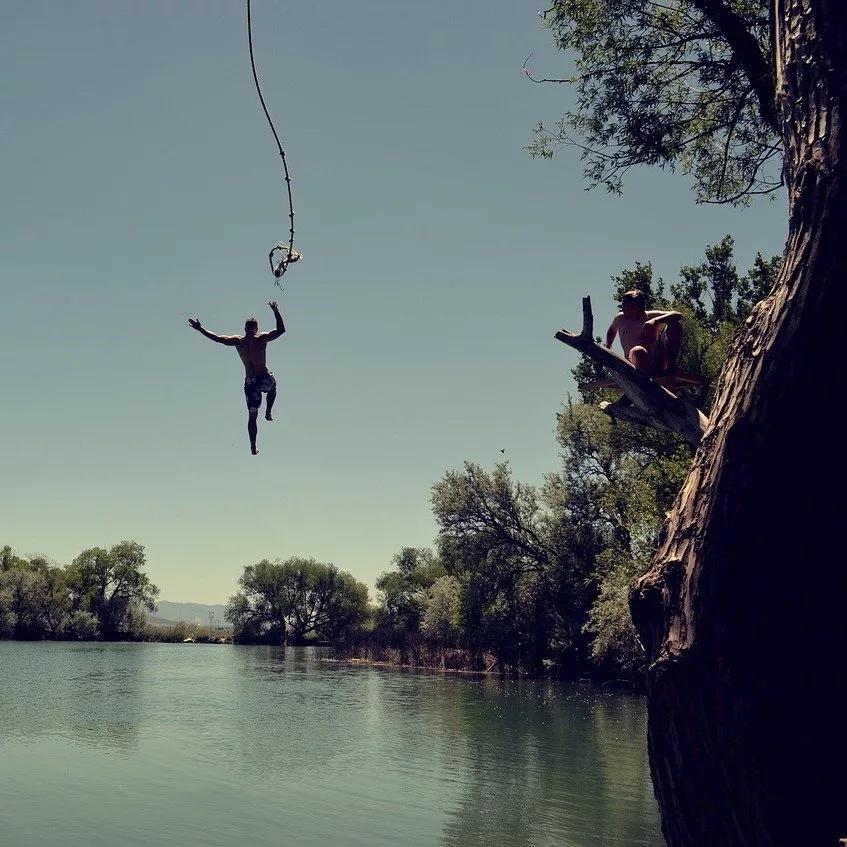 man jumping in the river